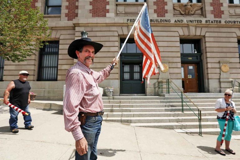 Bruce Leibold protests Montana’s mask mandate in front of the Mike Mansfield Federal Building and U.S. Courthouse in Butte. (AP Photo, Meagan Thompson)