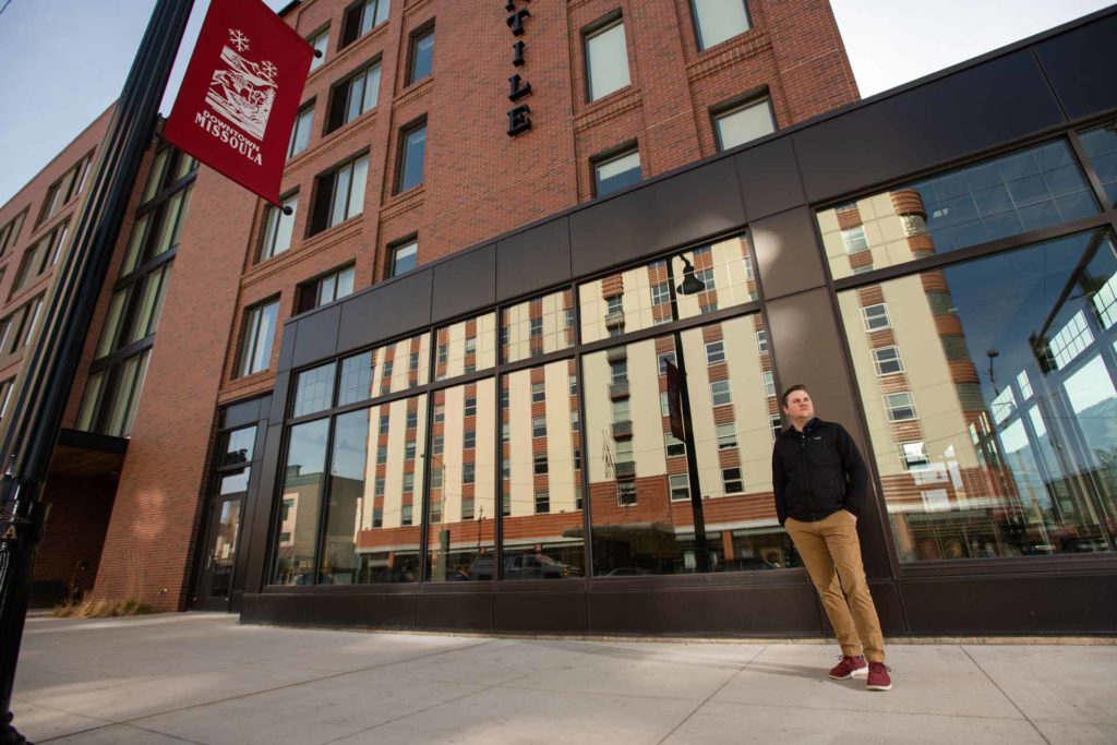 Ryan Hansen, founder of Lumenad, stands outside the Marriott Hotel in Missoula, as his Florence Building offices cast a reflection in the windows. (Lido Vizzutti)